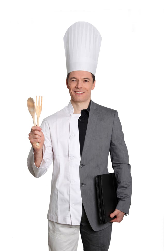 A man in a suit which is half a chef's outfit and half a suit.